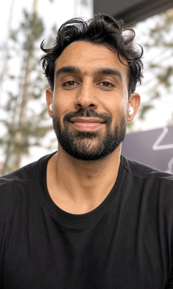 Jack, founder of THE MELT SOCIETY, smiling outdoors in a black T-shirt